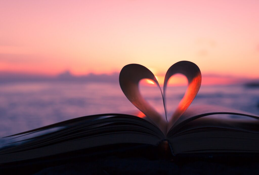 Heart from book against a beautiful sunset.